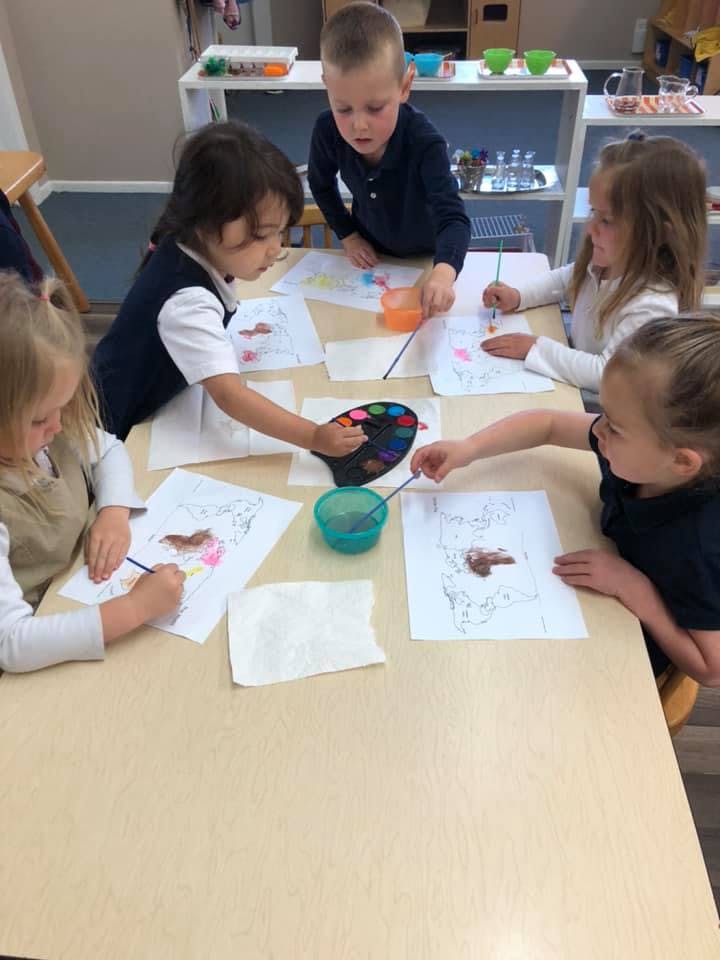 Children painting at a table