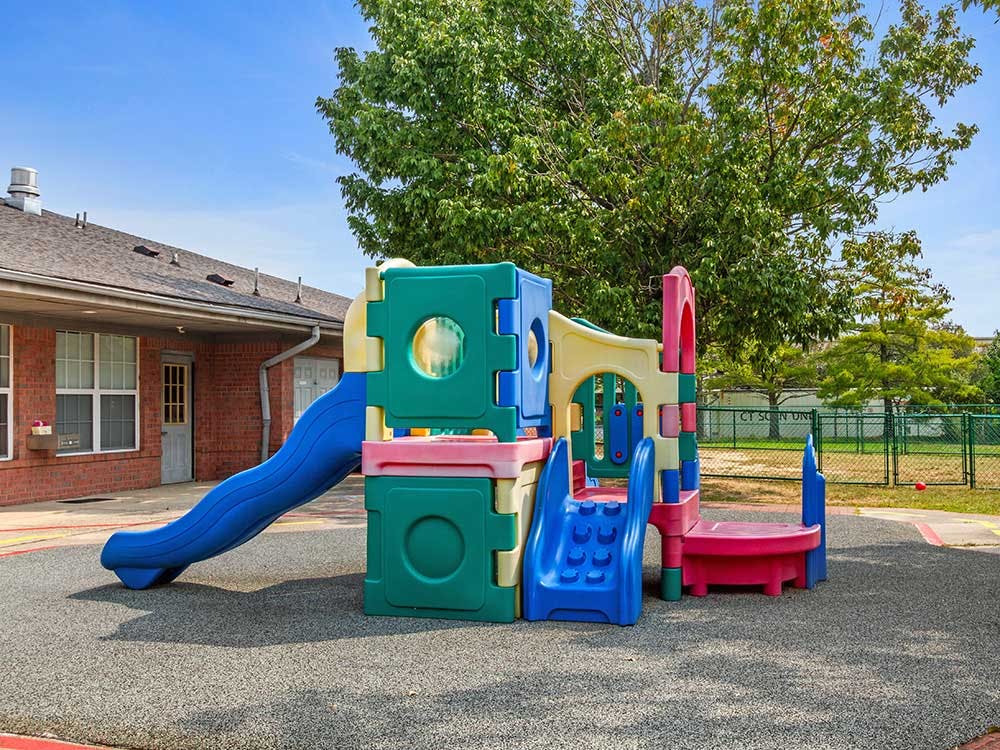 Colorful playground structure on rubber flooring