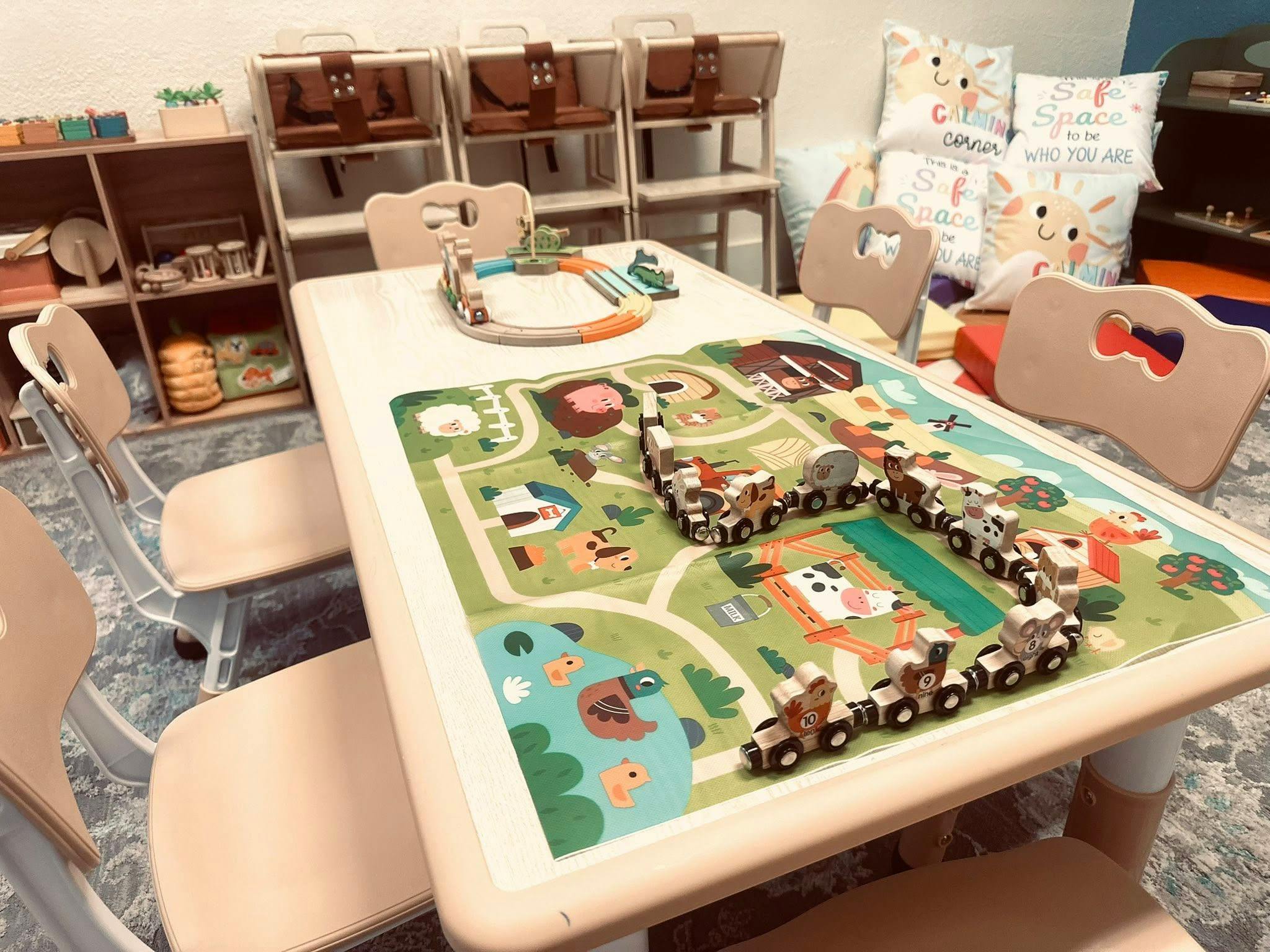 Playroom table with a playmat and toy trains
