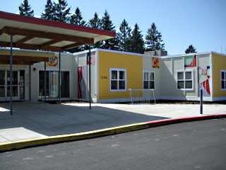 Exterior of a modular building with yellow and white walls