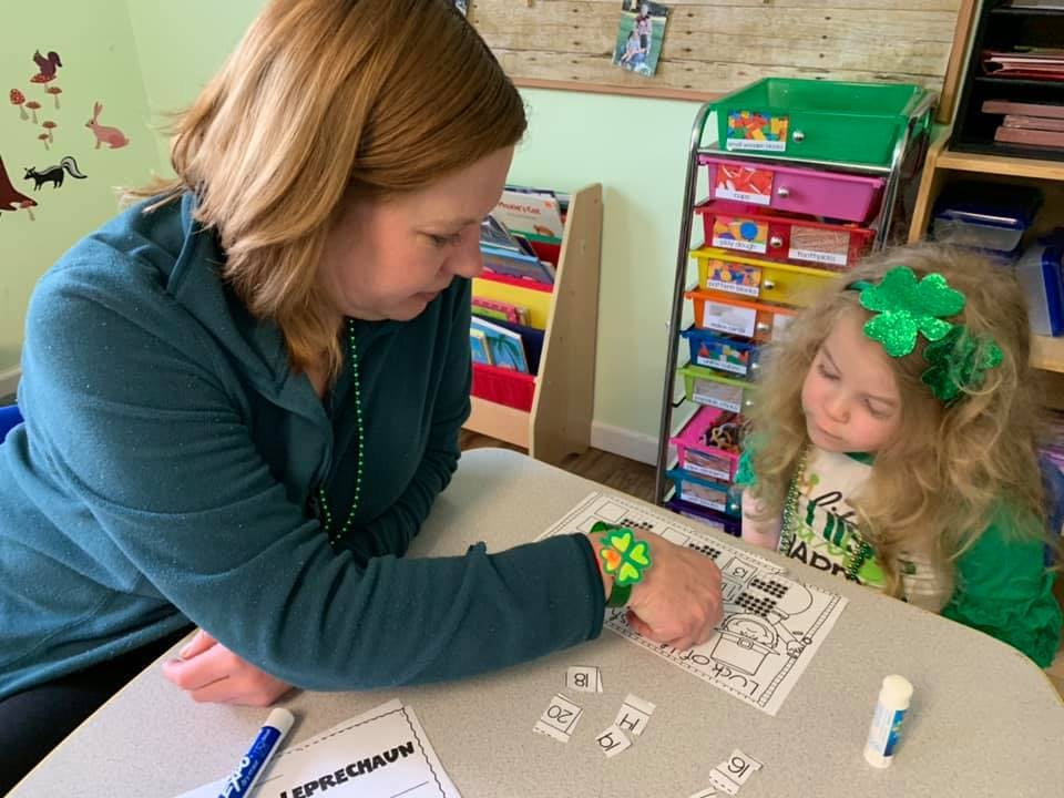 Adult and child looking at paper on a table