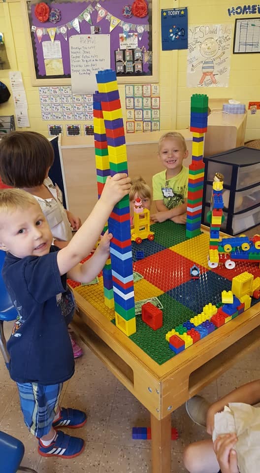 Children playing with colorful building blocks at a table