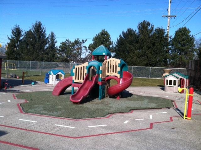 A colorful playground with slides and playhouses on a sunny day