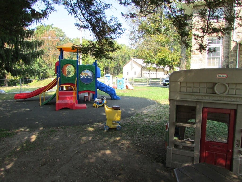 Playground with colorful slides and a small playhouse