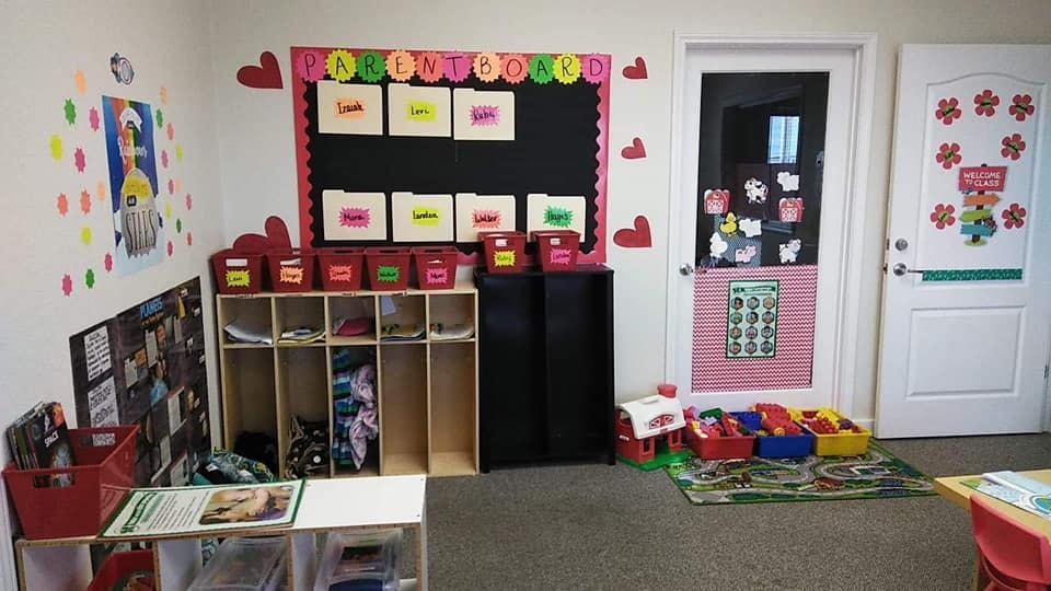 Classroom with cubbies, bulletin board, and decorated doors