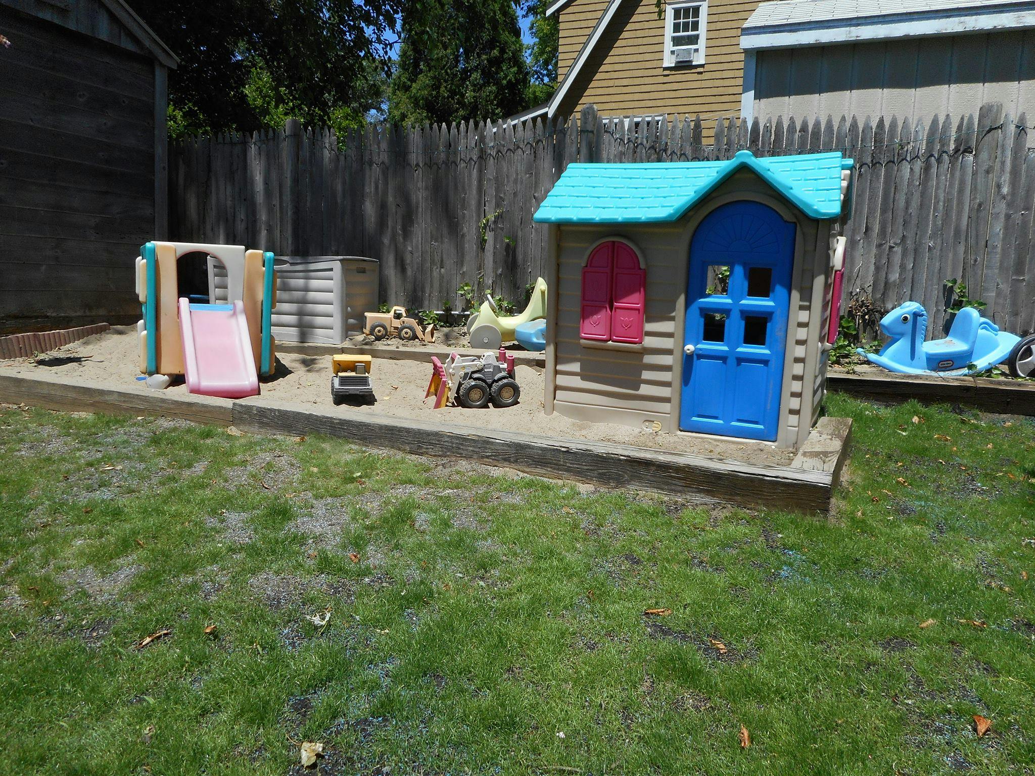 Playhouse and slide in a sandbox