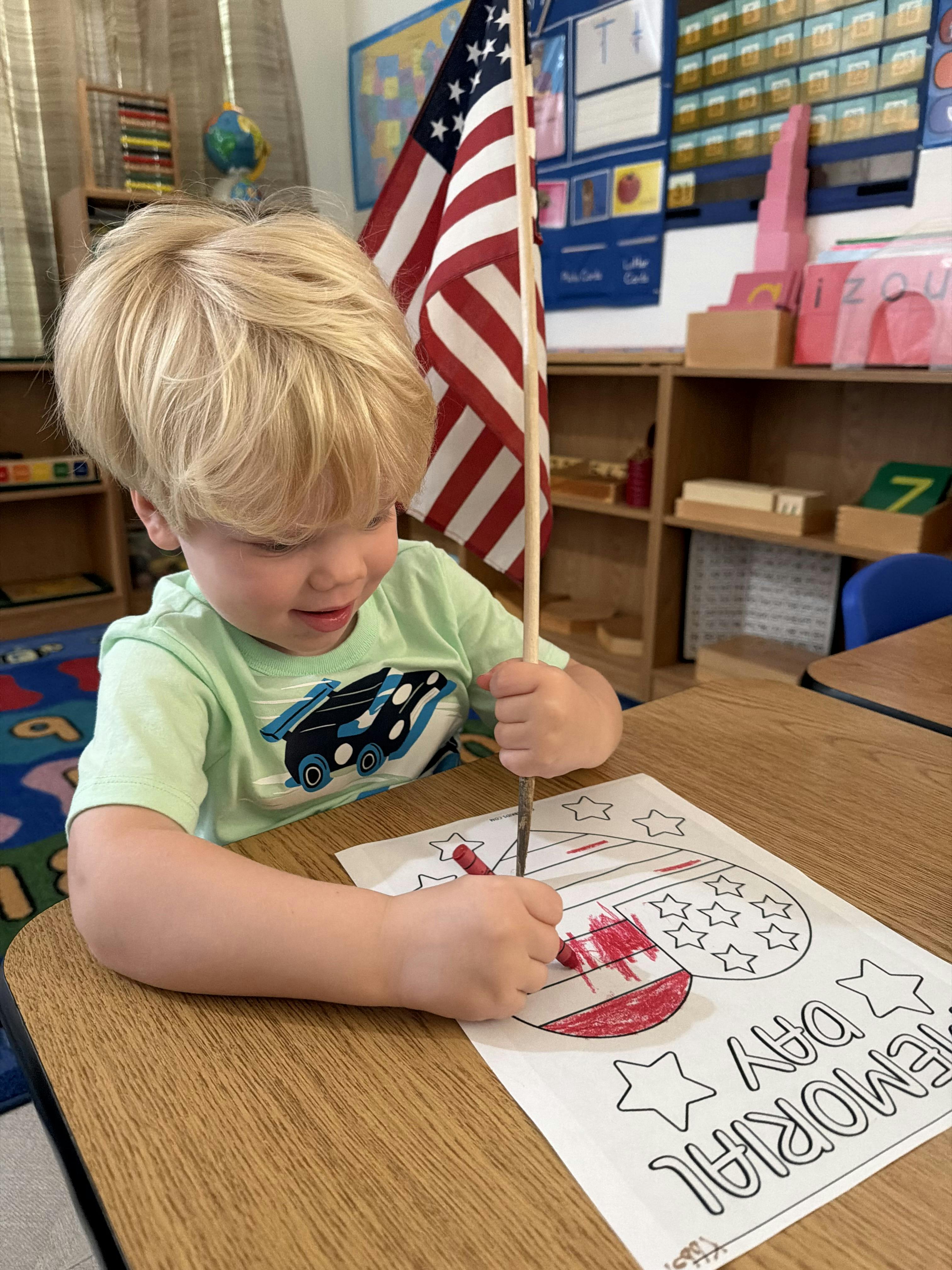 Child coloring a Memorial Day picture in a classroom
