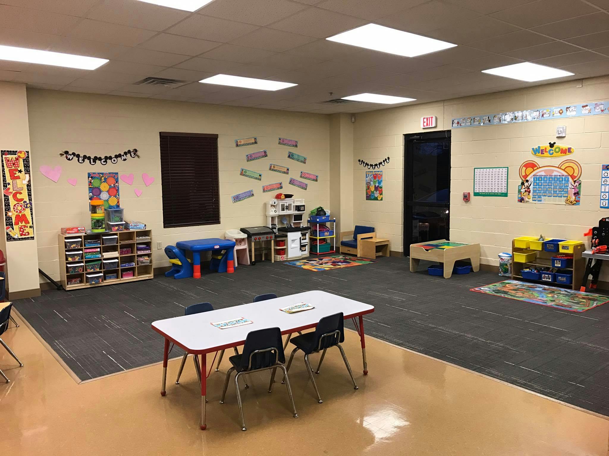 Empty classroom with small tables and chairs