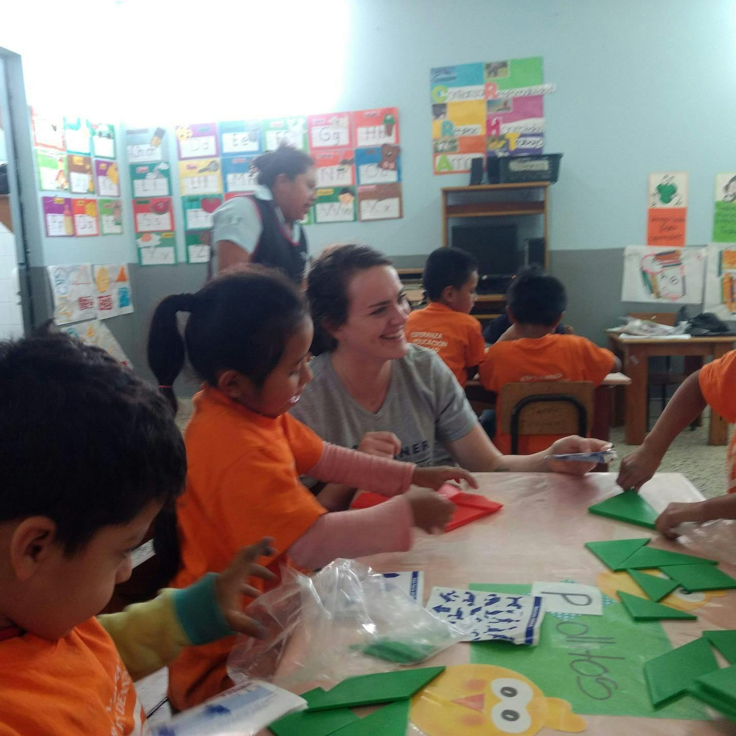 Adult and children at a table with craft supplies