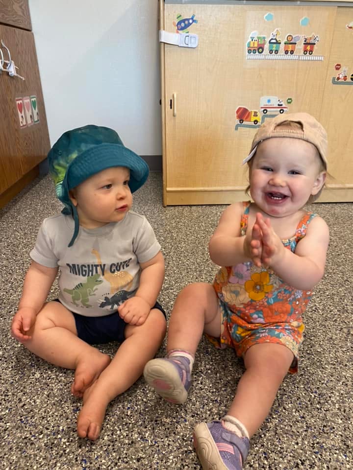 Two children sitting on the floor