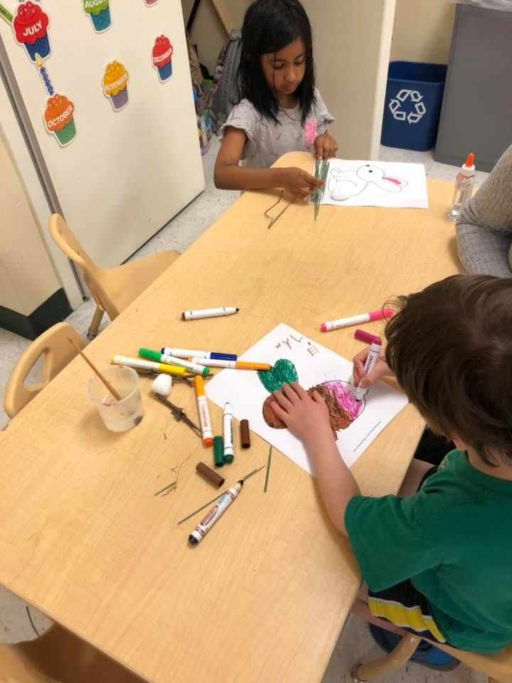 Two children drawing at a table