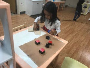 Child playing with blocks at a table
