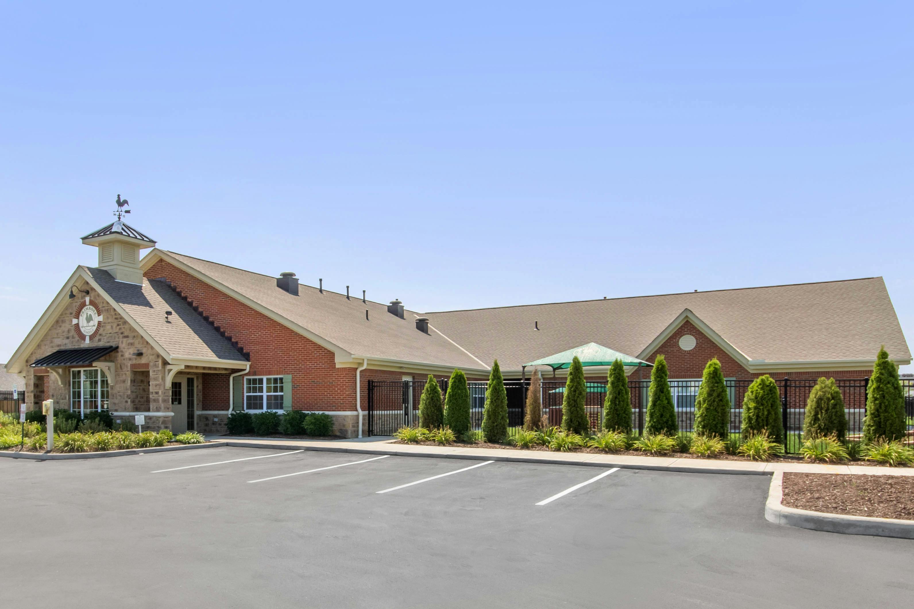 Brick building with stone accents and a weather vane on the roof
