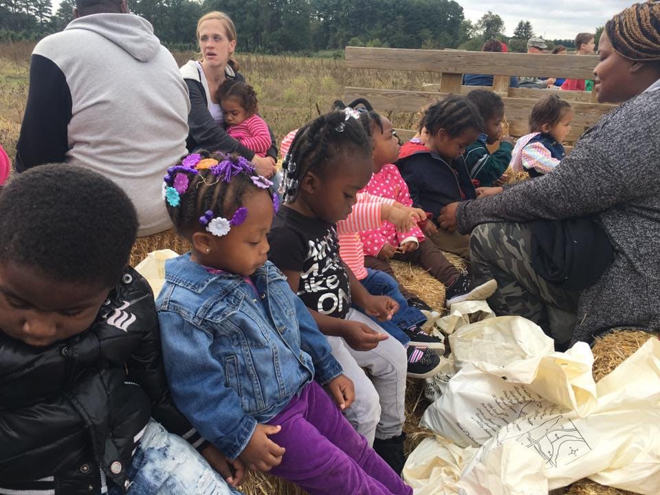 Adults and children sitting outdoors