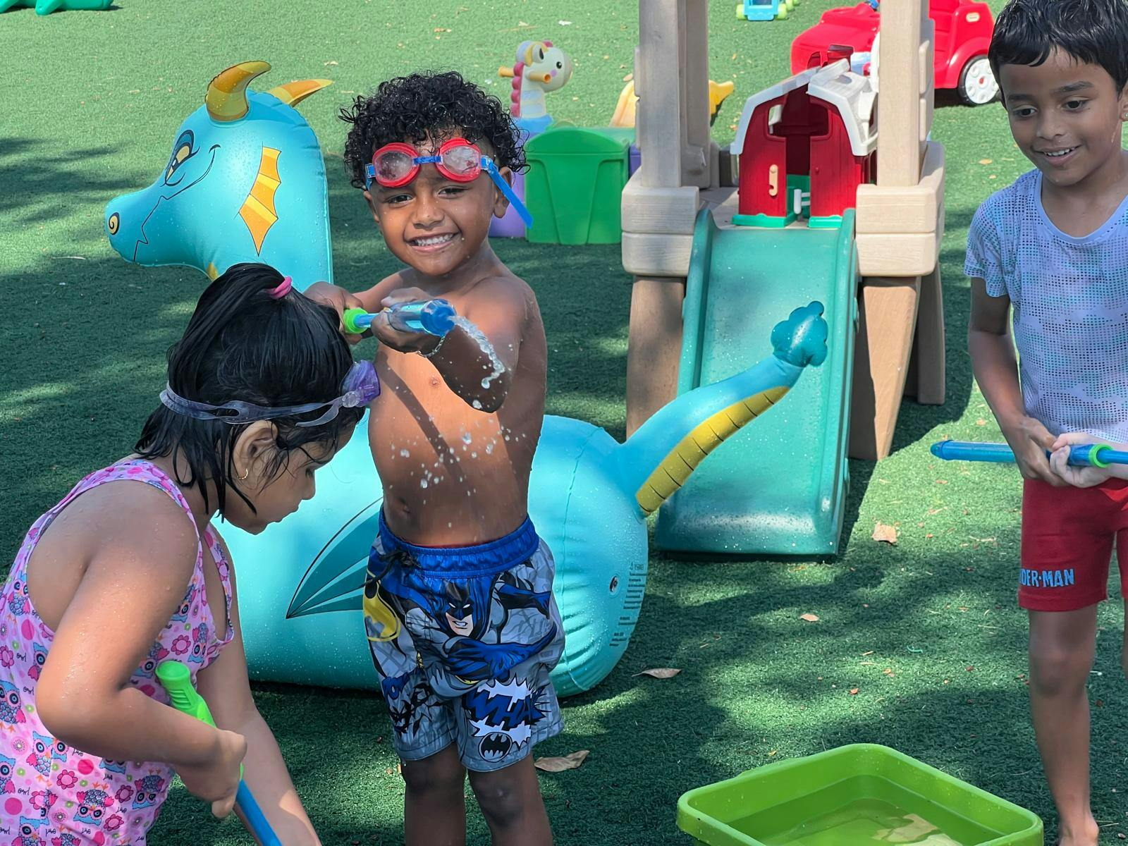Children playing with water guns outdoors
