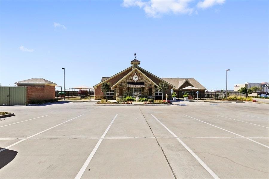 Empty parking lot in front of a building with a steeple