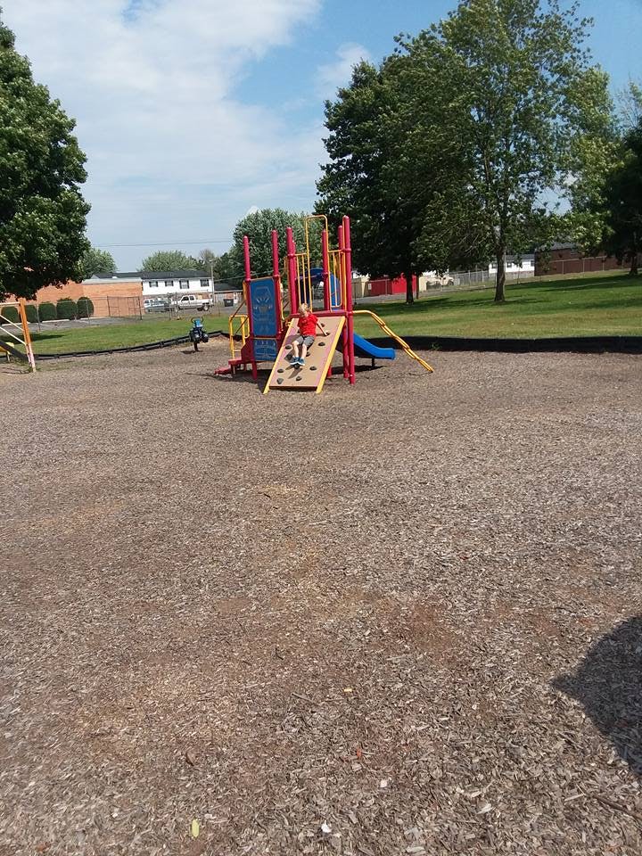 Child on a climbing wall at a playground