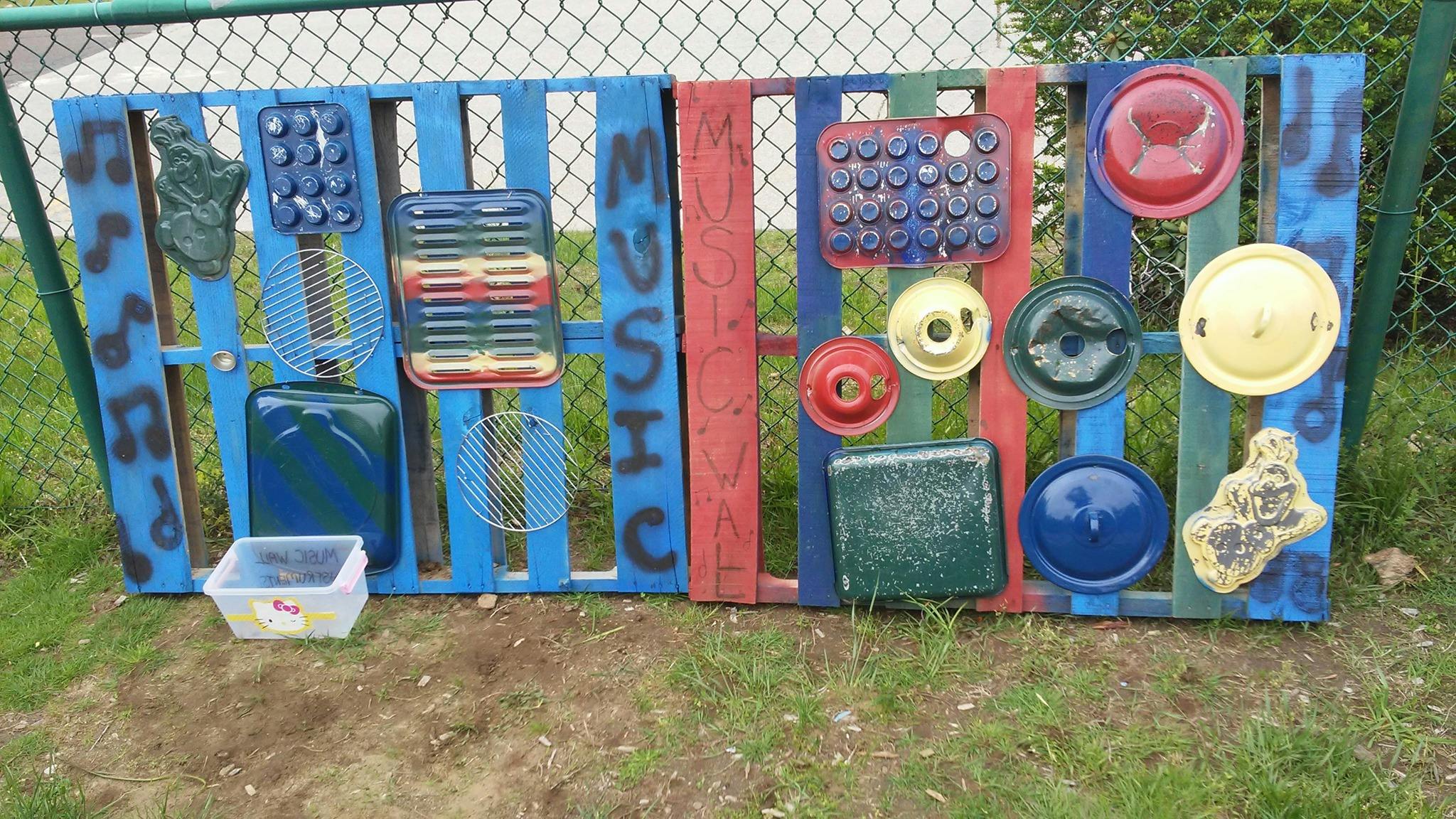 Pallet fence with various kitchen items attached, text says MUSIC