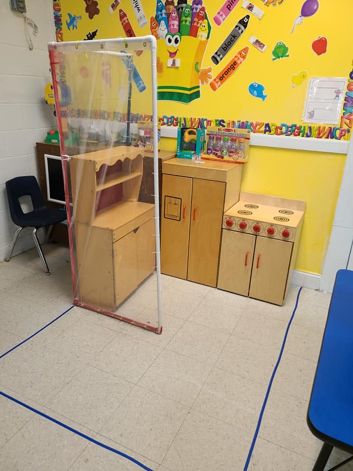 Classroom with play kitchen and clear divider