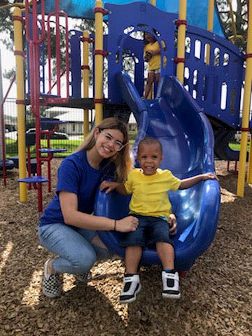 Person and child on a playground slide