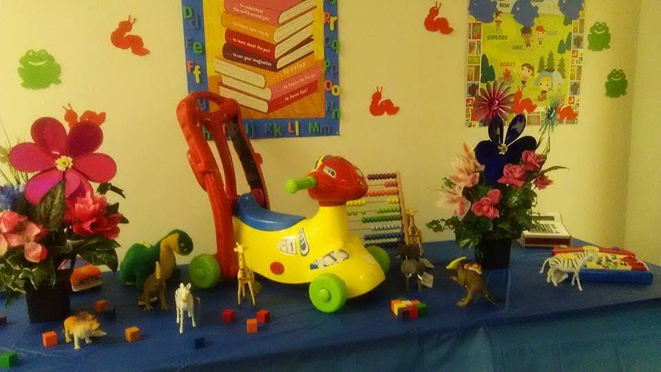 Child's ride-on toy and animal figurines on a table