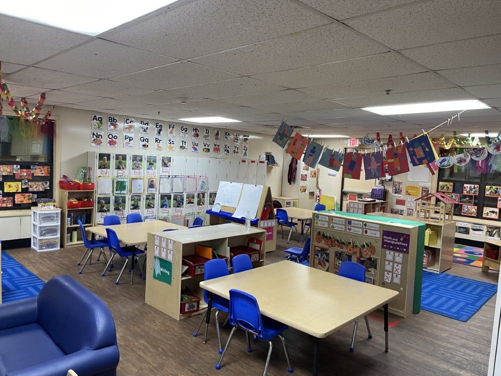 Empty colorful children's classroom with small tables and chairs