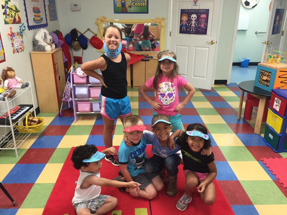 Group of children posing in a classroom