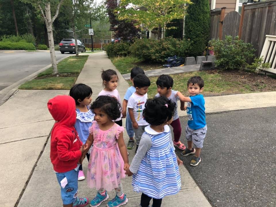 Group of children standing on a sidewalk