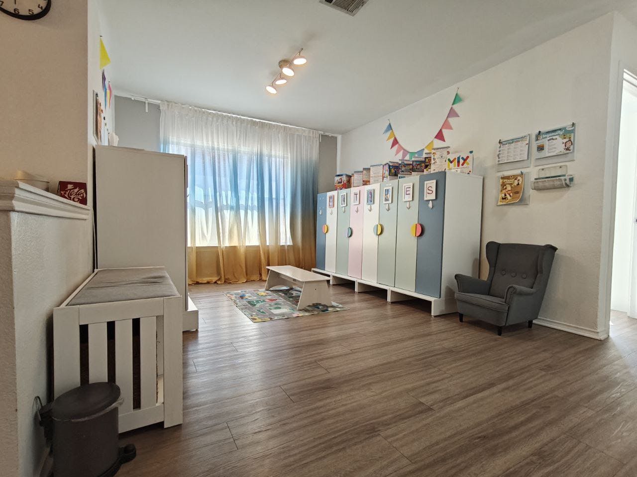 Classroom with lockers, a bench, and a chair