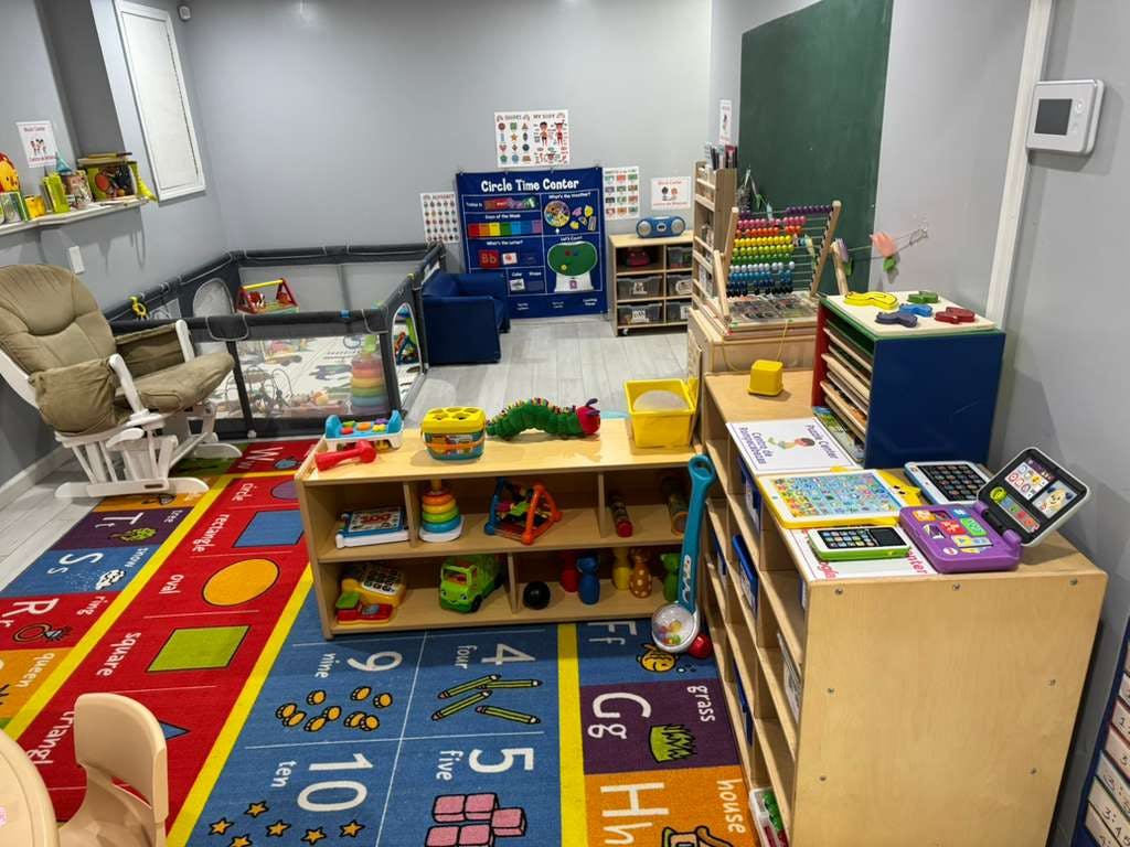 Childcare classroom with educational toys and alphabet rug