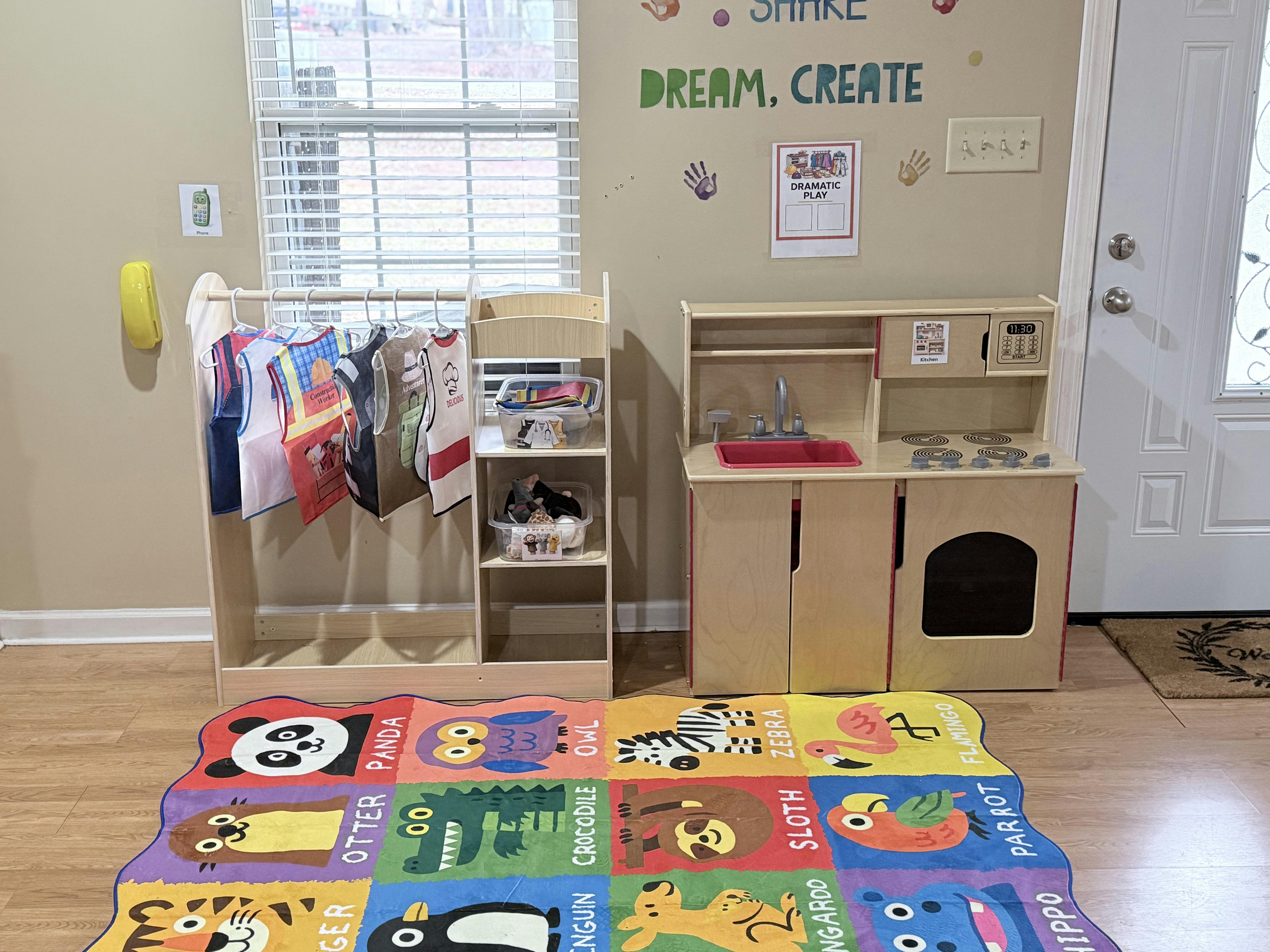 play kitchen and dress-up rack with a colorful animal rug