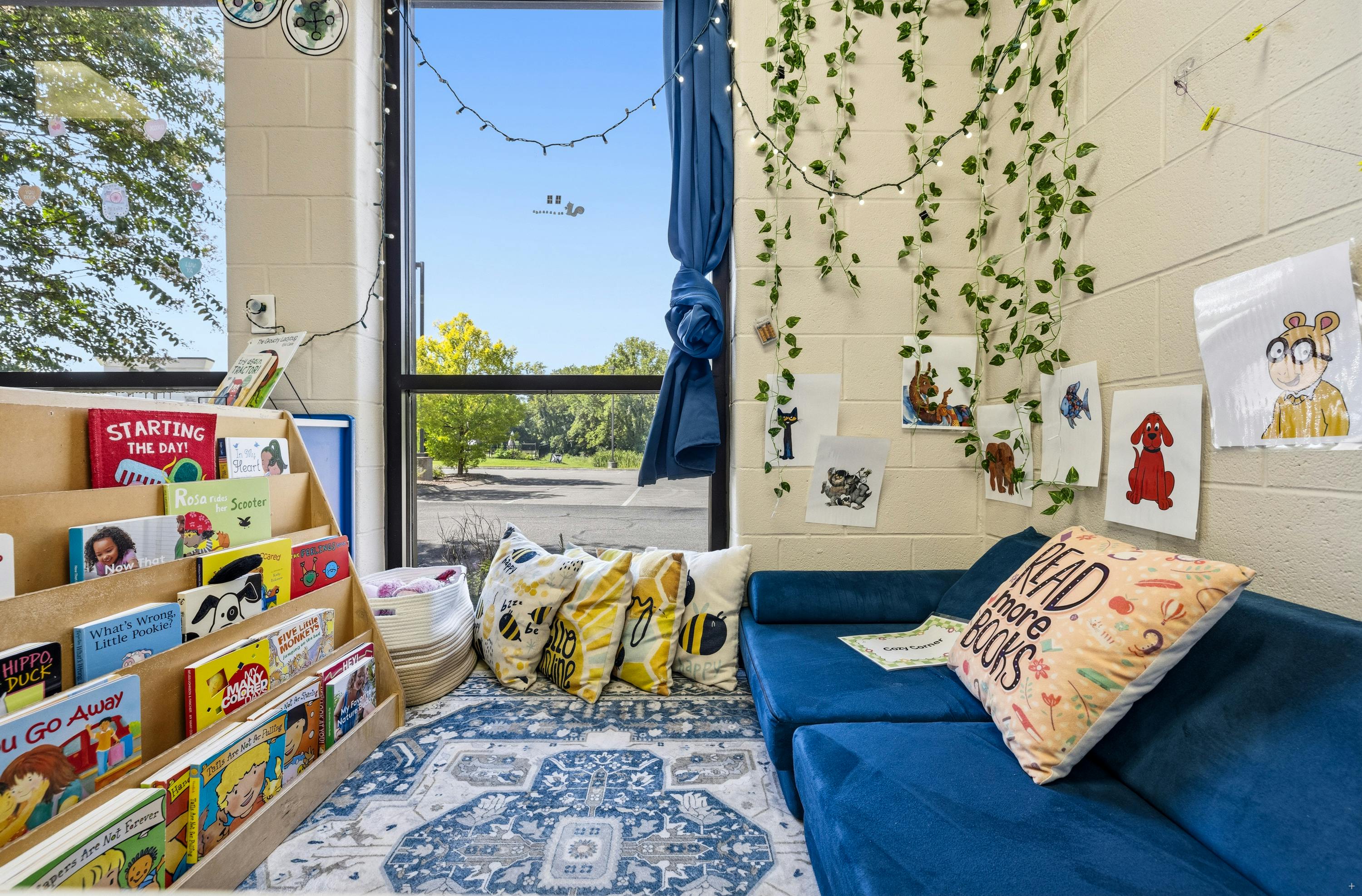 Cozy reading corner in a classroom with a bookshelf, sofa, and pillows