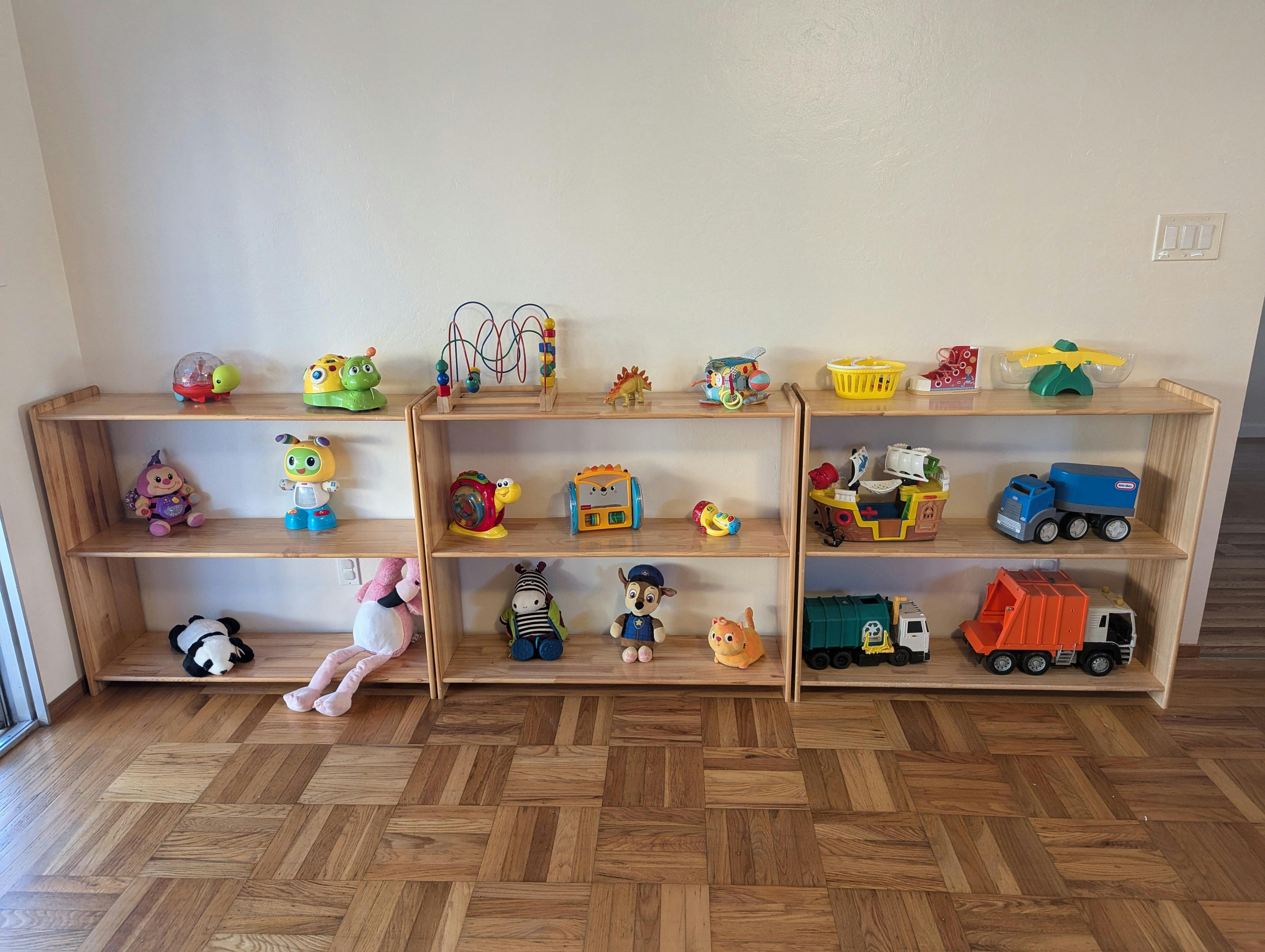 Children's toys displayed on wooden shelves