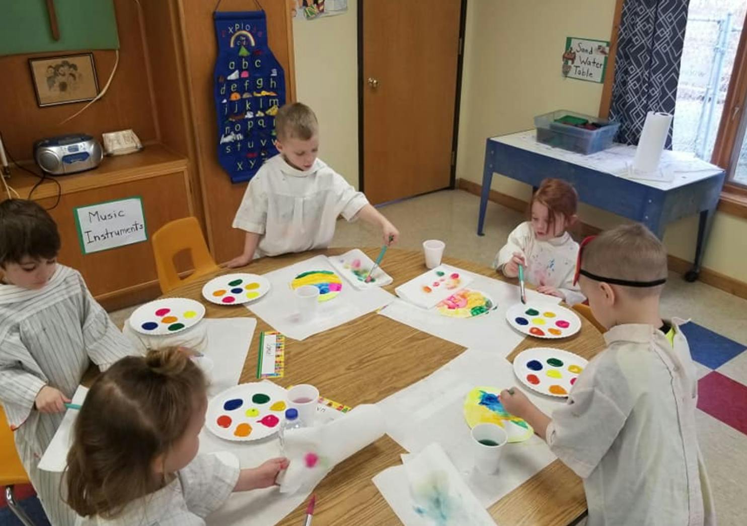 Children painting at a table