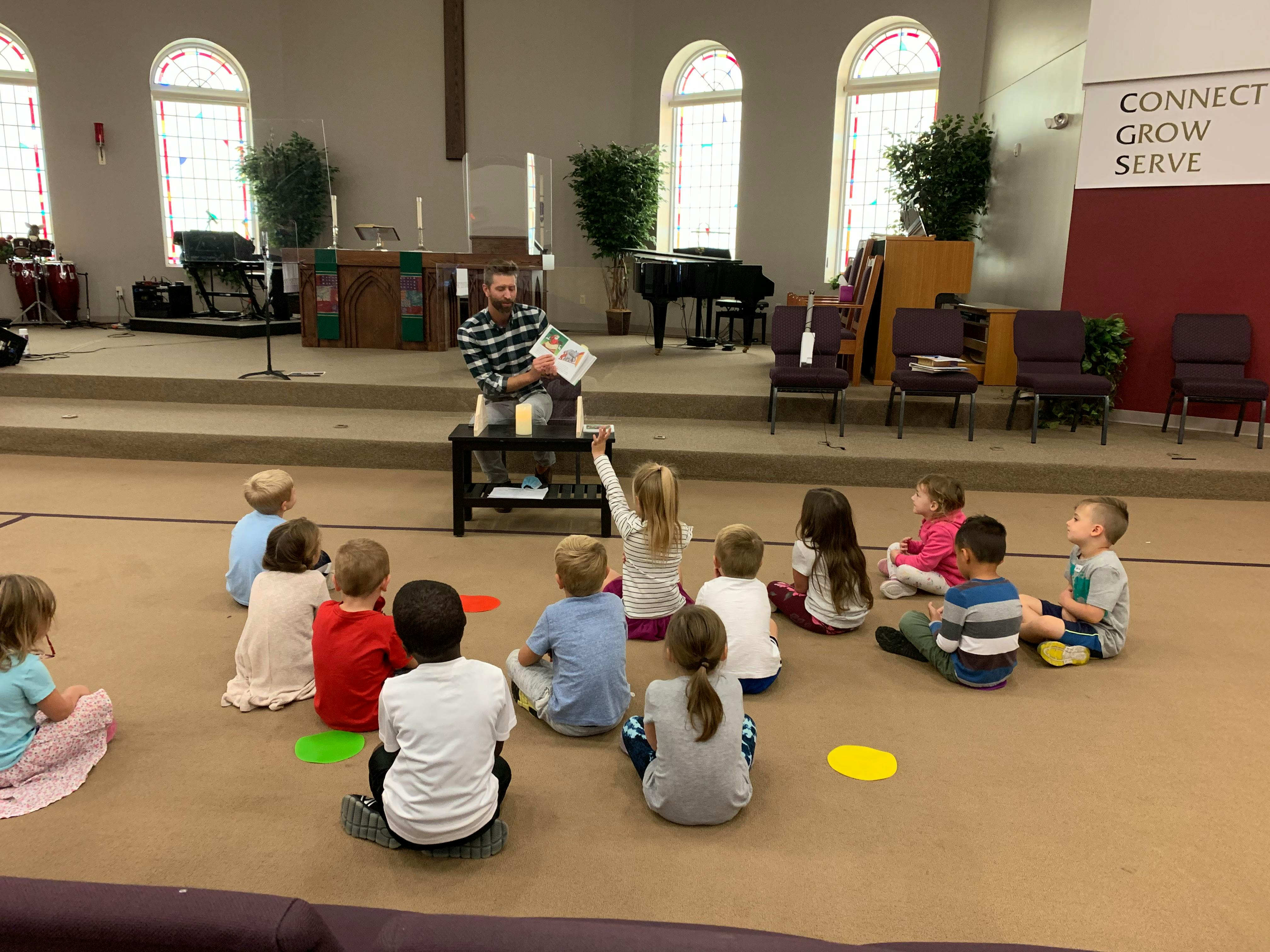 Adult reading to children sitting on the floor