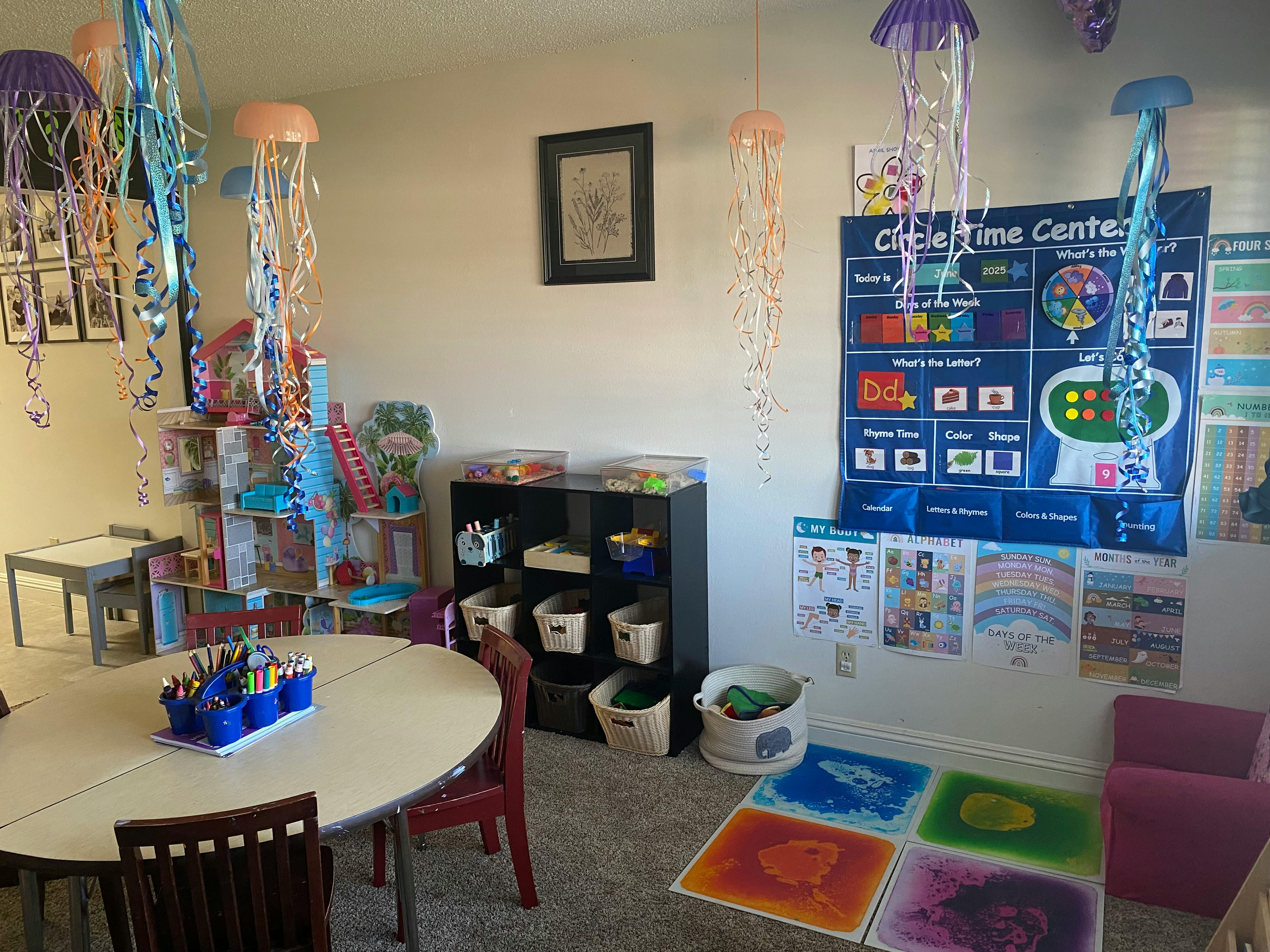 Classroom with tables, chairs, storage shelves, and wall decorations