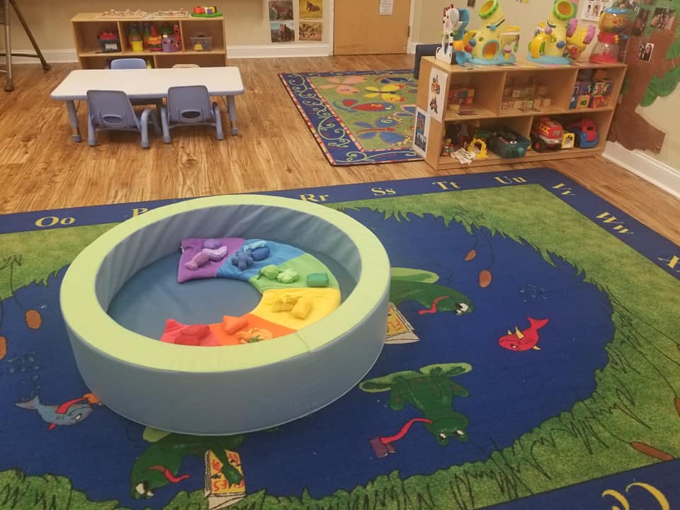 Playroom with a soft play ring and colorful rug