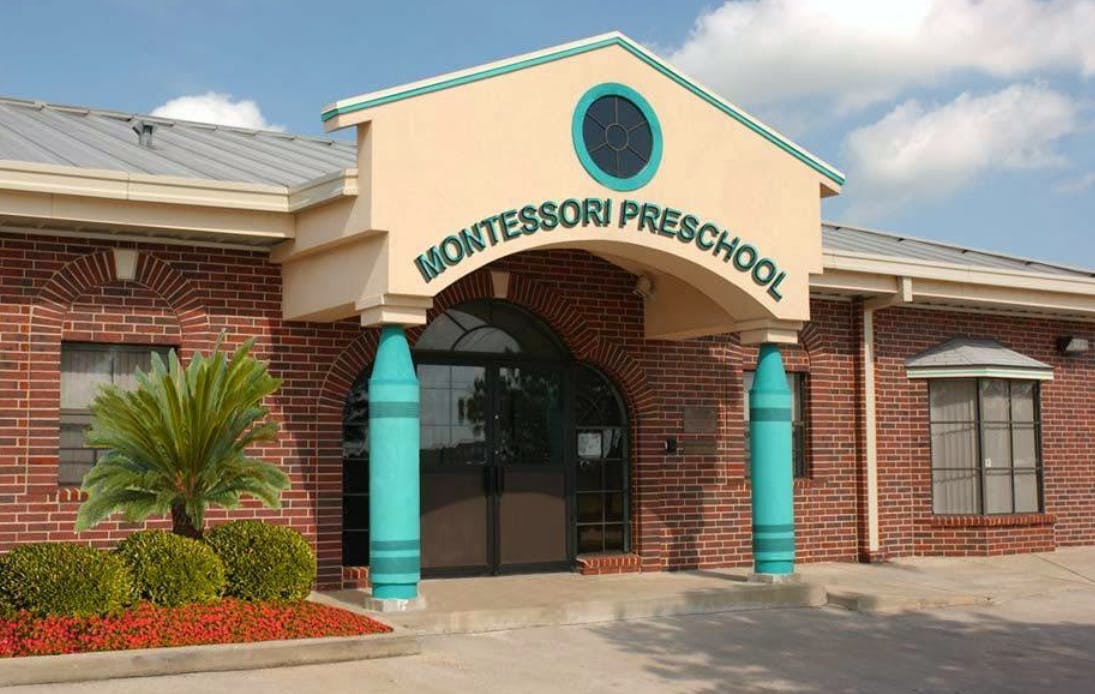 Montessori Preschool building entrance with brick facade and teal crayon-shaped columns