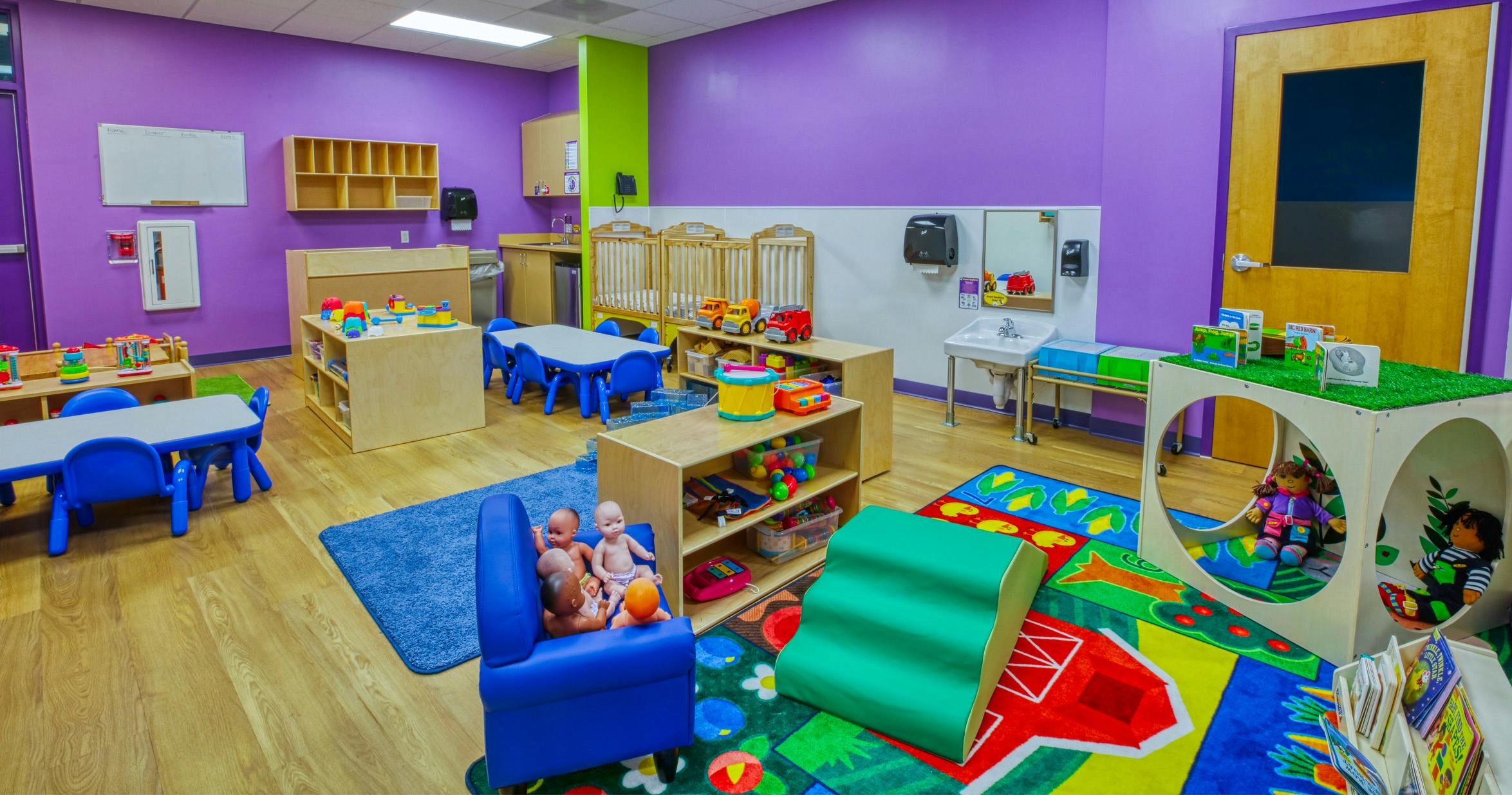 Classroom with purple walls and various colorful toys