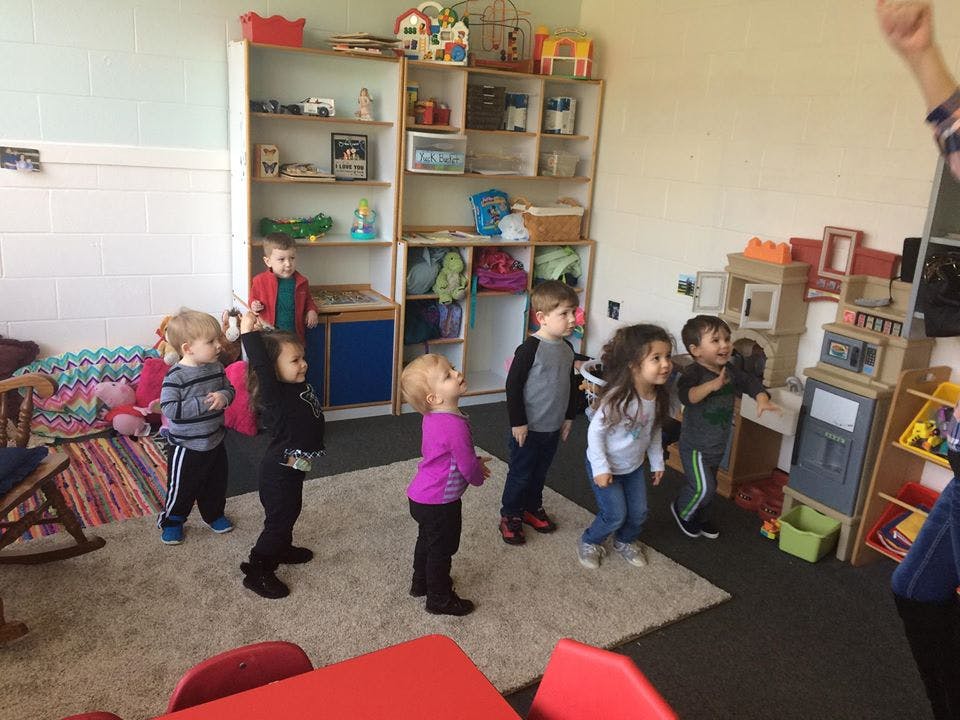 Children standing in a classroom