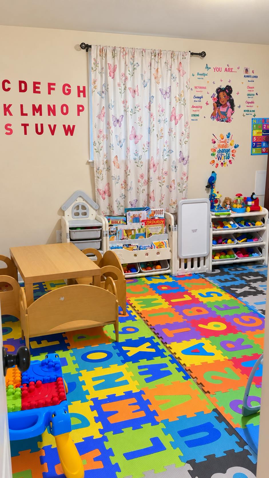 Colorful playroom with alphabet floor mats, toy shelves, and a child-size table