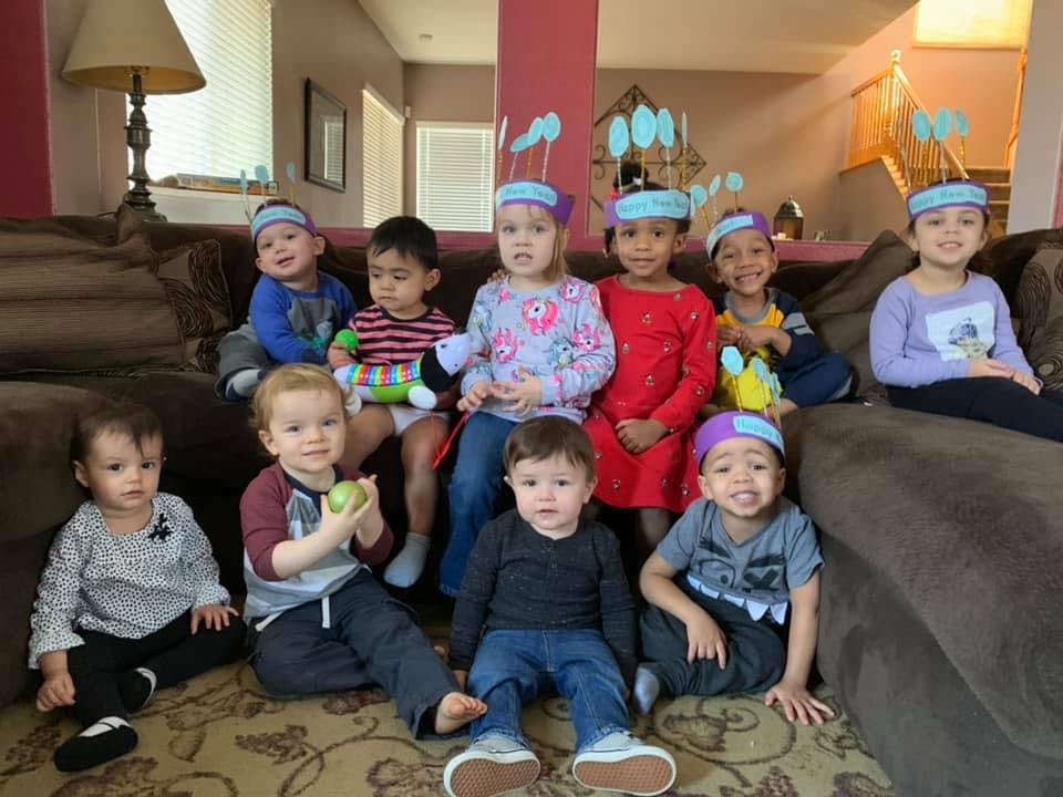 Group of children and toddlers sitting on a couch and floor
