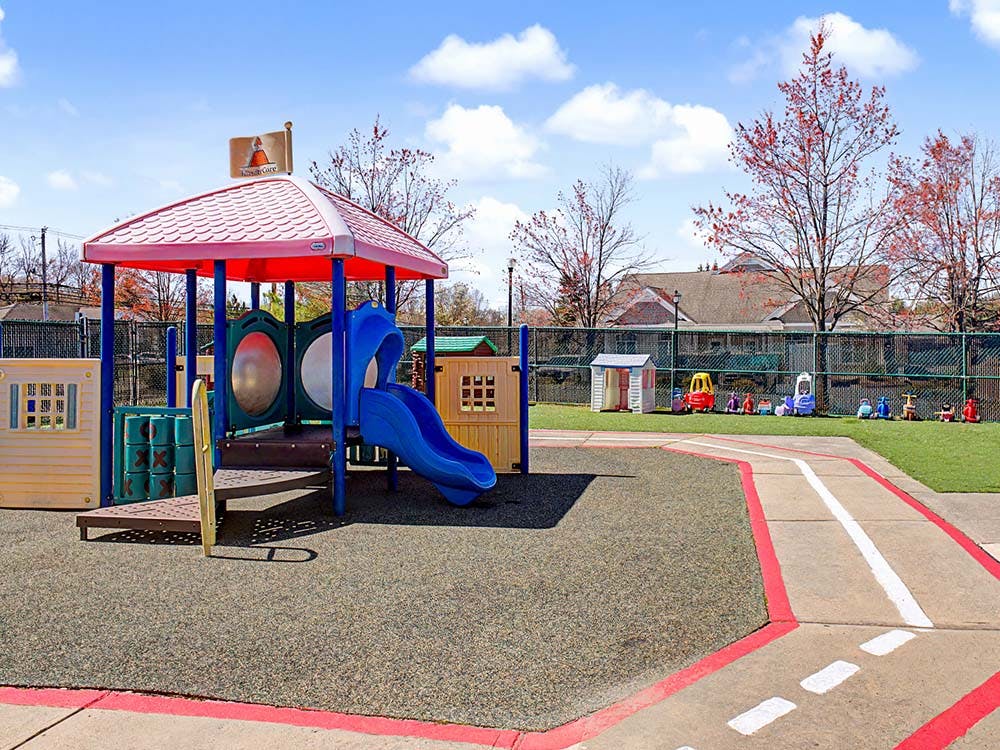 Playground with a play structure and slide on soft ground