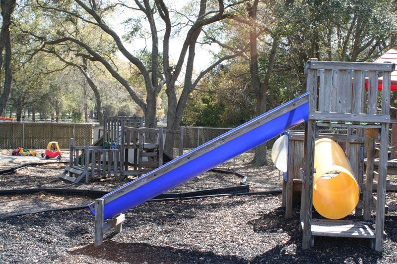 Playground with blue slide and yellow tunnel slide