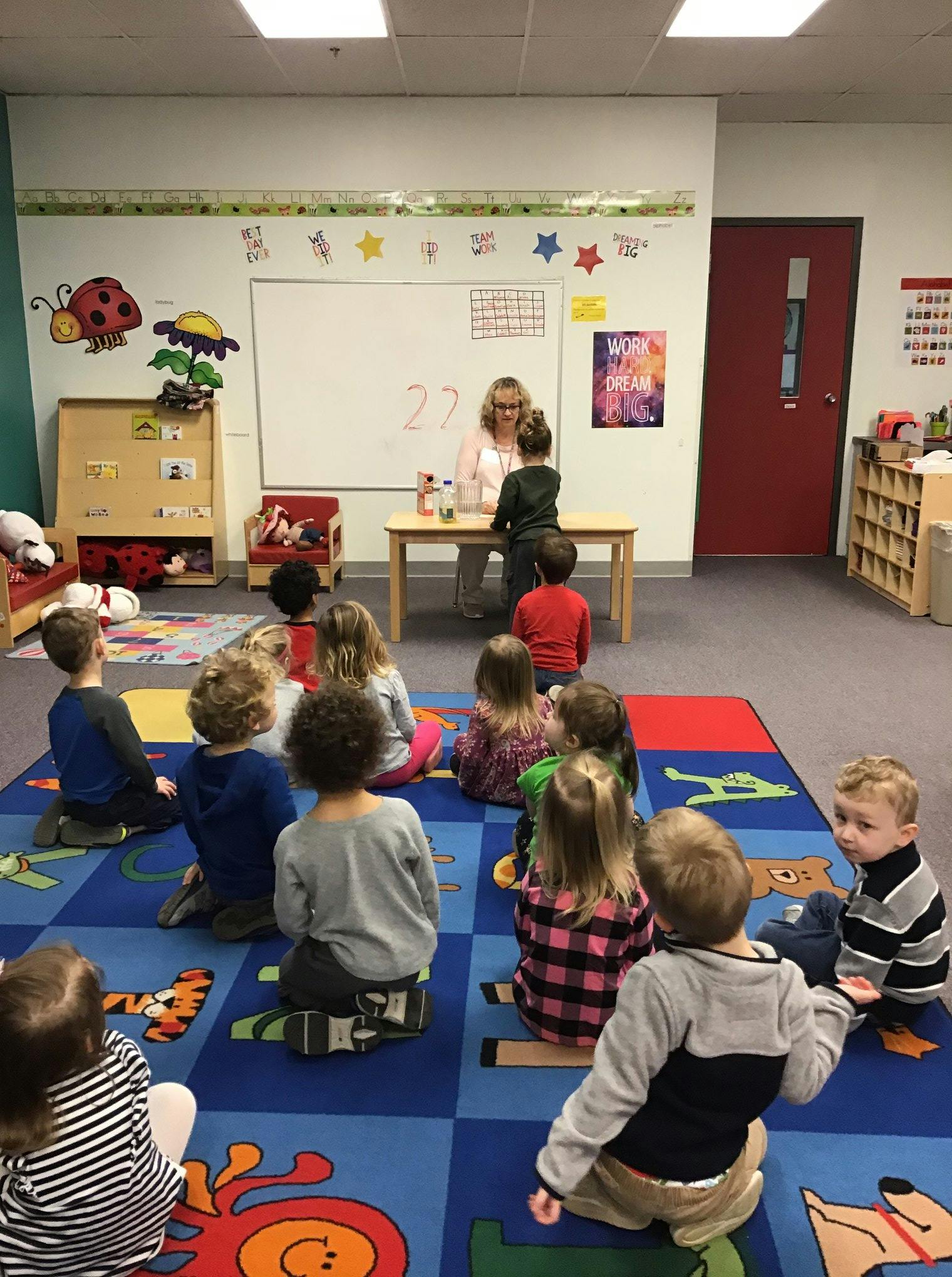 Person teaching a group of children in a classroom