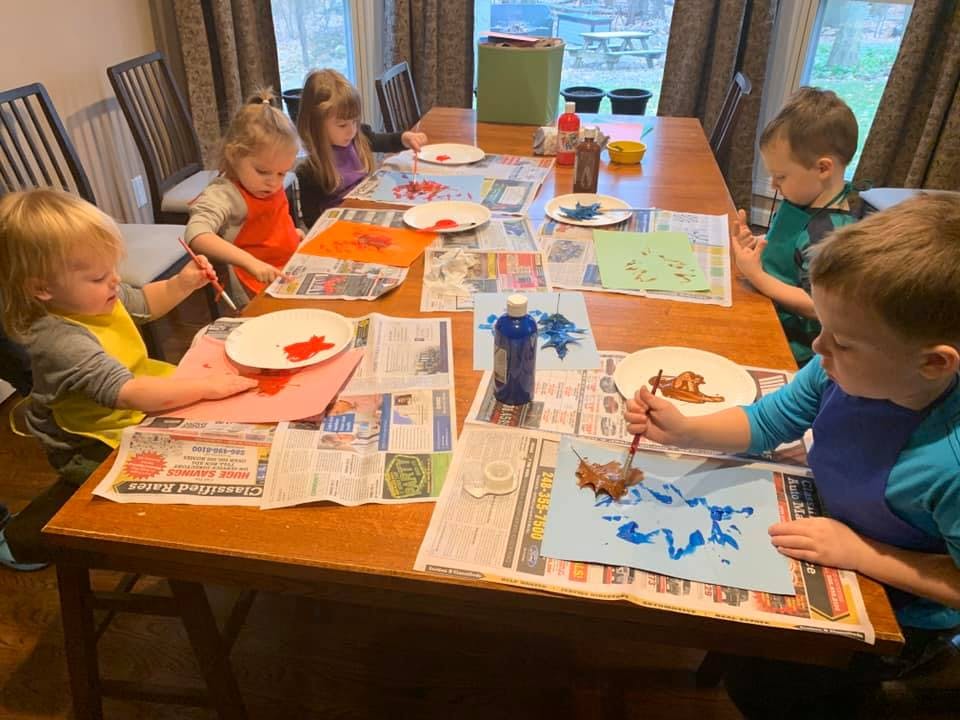 Children painting at a table