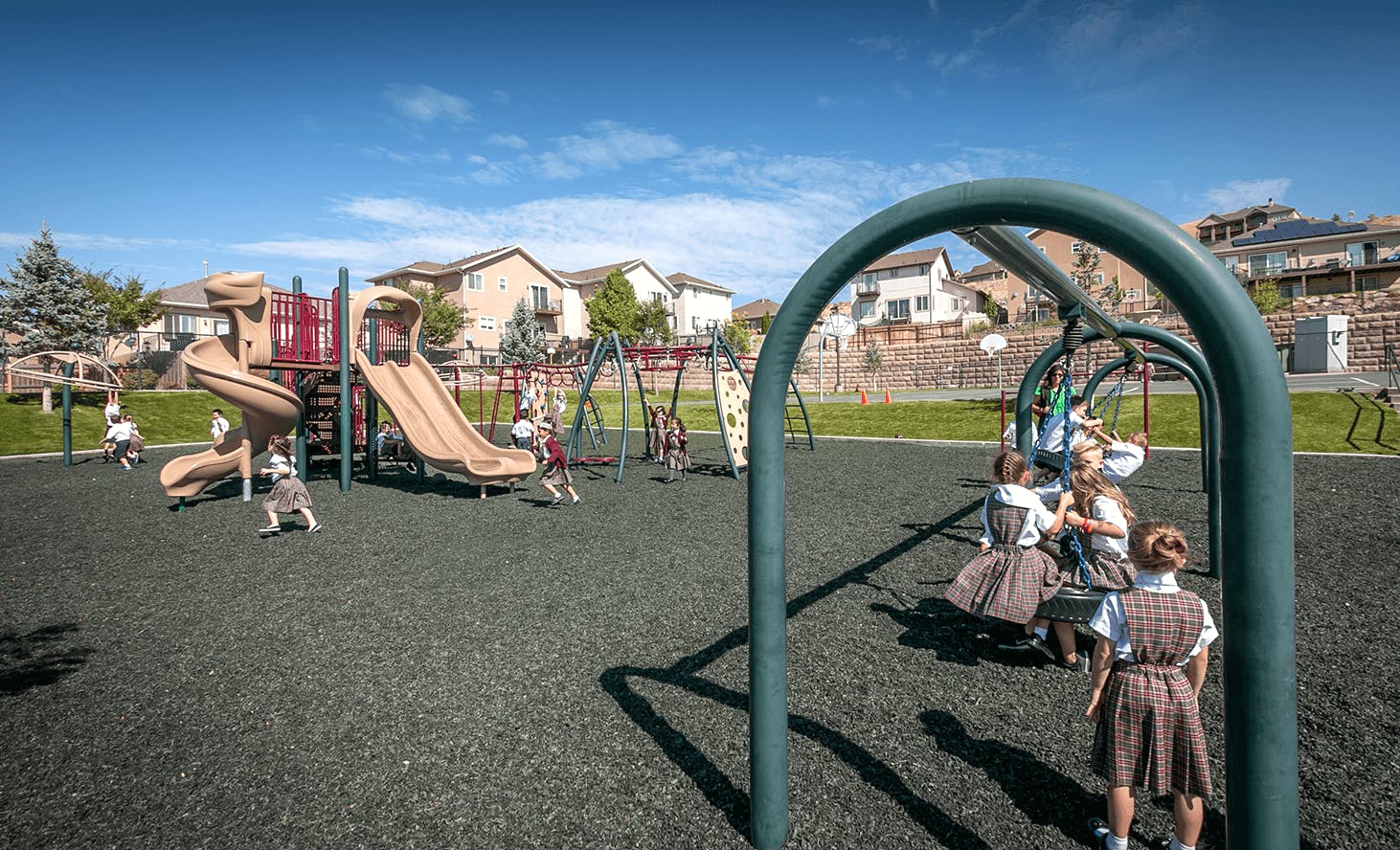 Children playing on a playground with slides and swings