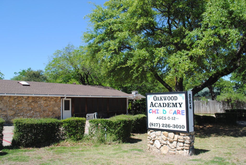 Oakwood Academy Child Care sign in front of a building
