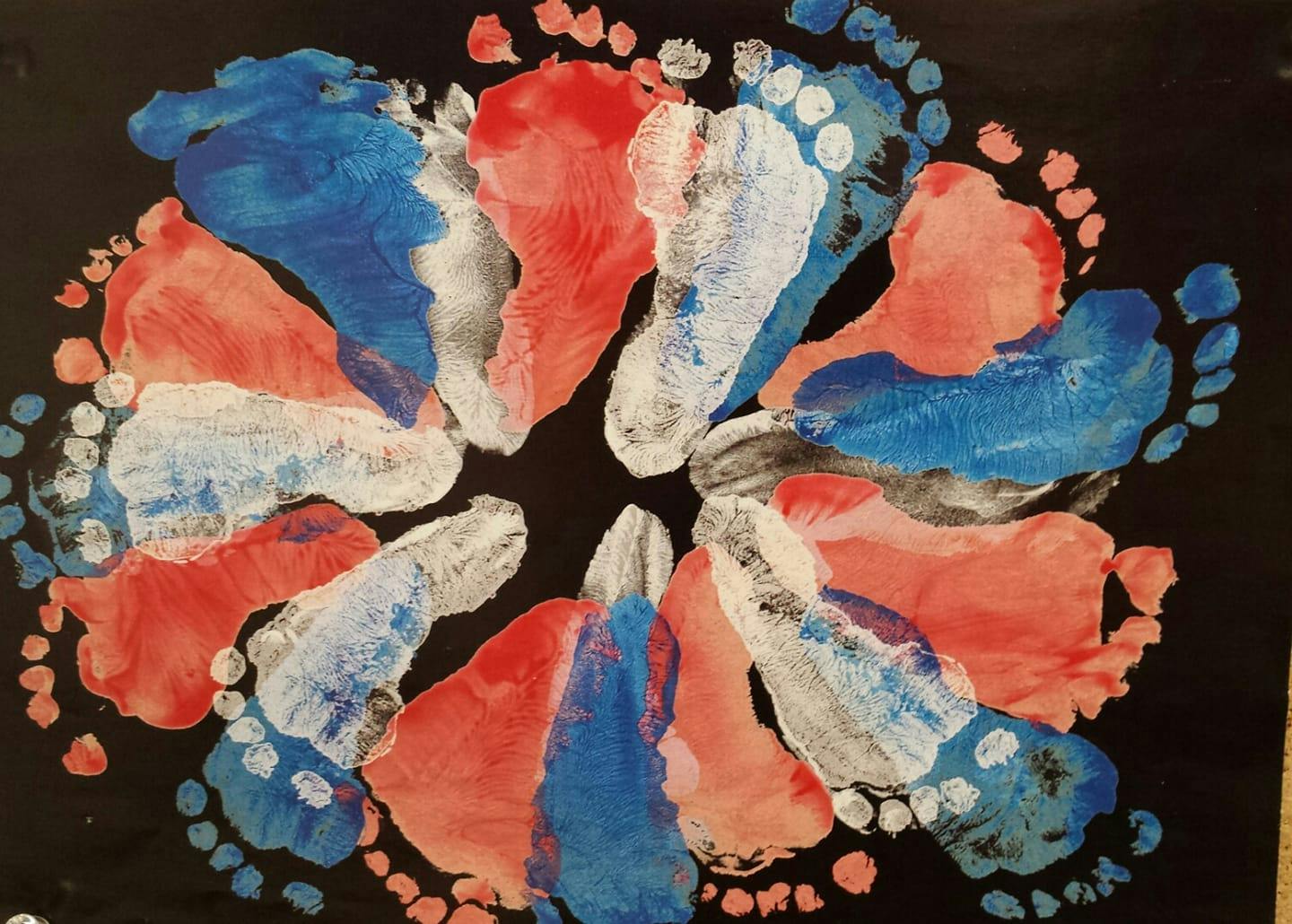 Red, white, and blue painted footprints arranged in a circle