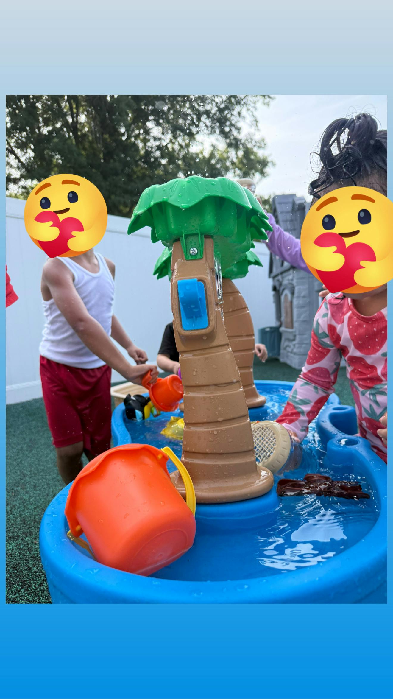 Children playing with a water table outdoors